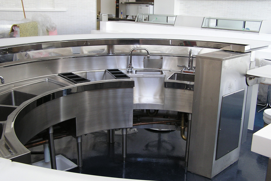 image of custom backbar equipment showing curved three compartment sink, single dump sink with drink wells and one compartment sink at Kumo Los Angeles