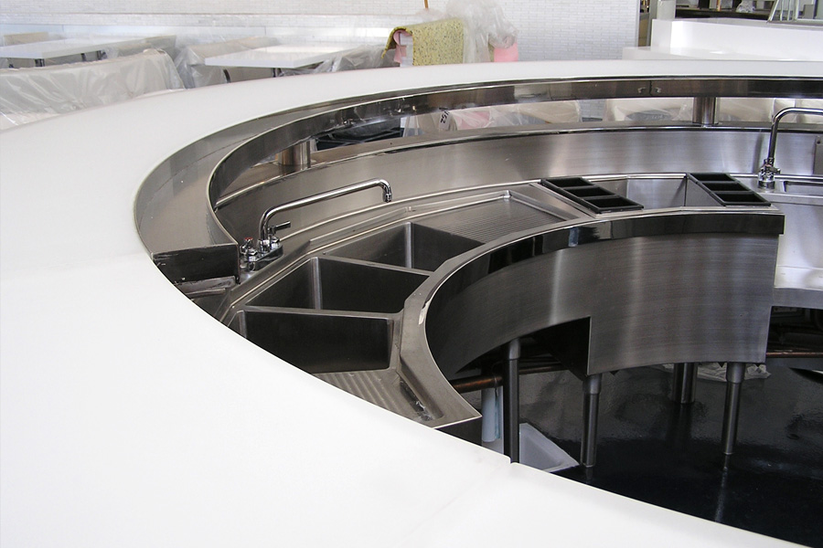 image of counter with single speed rail, custom three compartment sink and dump sink at Kumo Los Angeles