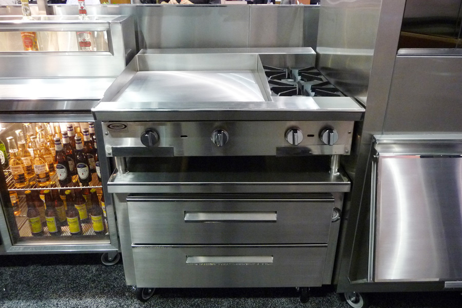 image of trade show booth at NAFEM showing various restaurant equipment
