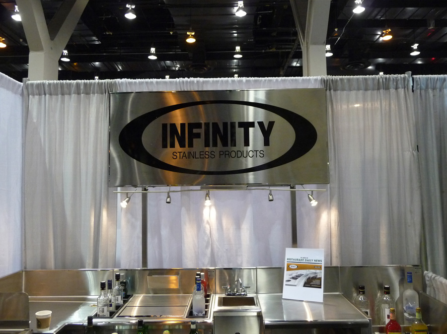 image of trade show booth showing steel logo sign with word infinity stainless products