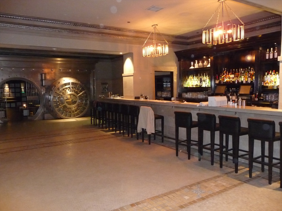 image of bar with bar stools and faux vault in background at crocker club los angeles