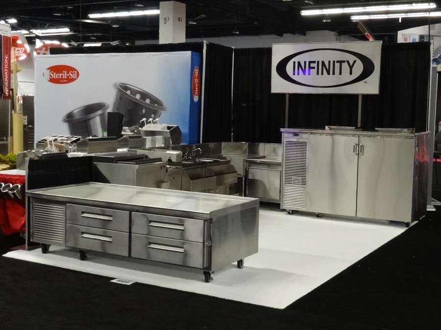 image of infinity trade show booth with low height with drawers refrigerator, bottle cooler, two compartment sink and backbar with doors