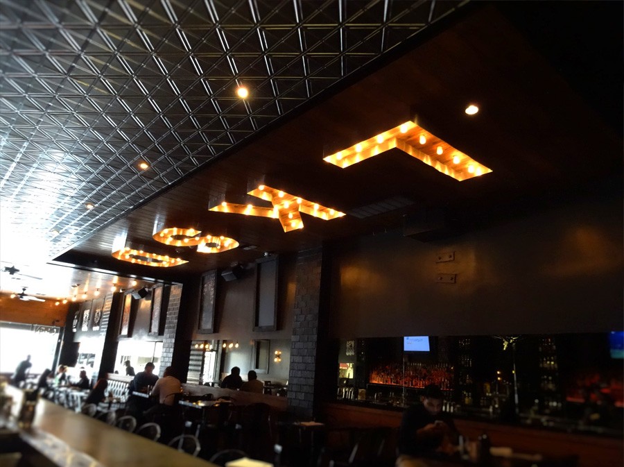 image of bar with LKSD illuminated on ceiling