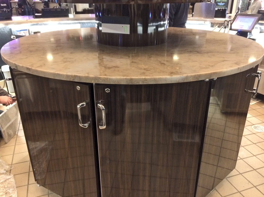 image of circular backbar equipment with marble top and faux wood grain veneer